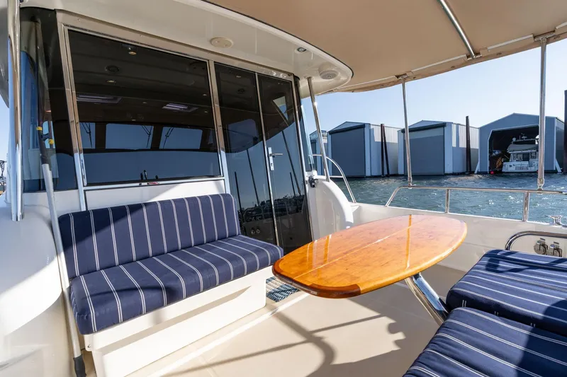 Jackson Yacht Photos Pics 2013 Sabre 38 Salon Express yacht interior with striped seating and wooden table.