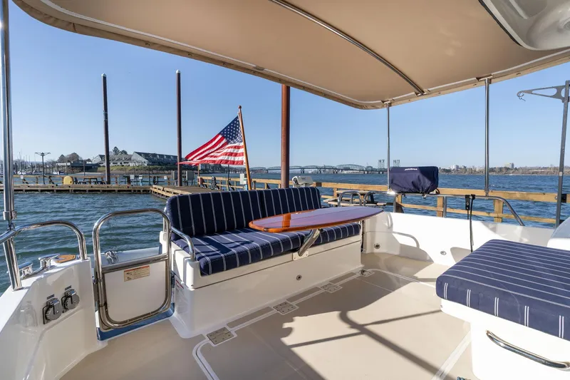 Jackson Yacht Photos Pics 2013 Sabre 38 Salon Express yacht interior with striped seating and American flag.