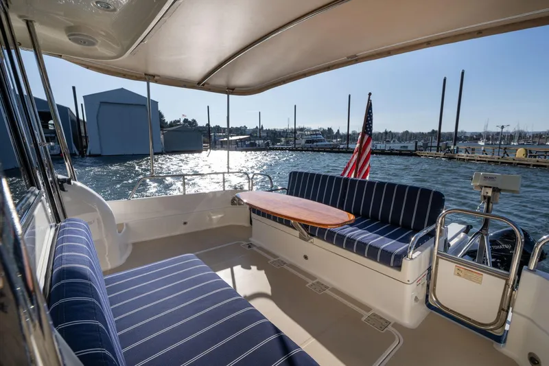 Jackson Yacht Photos Pics 2013 Sabre 38 Salon Express yacht interior with striped seating and marina view.