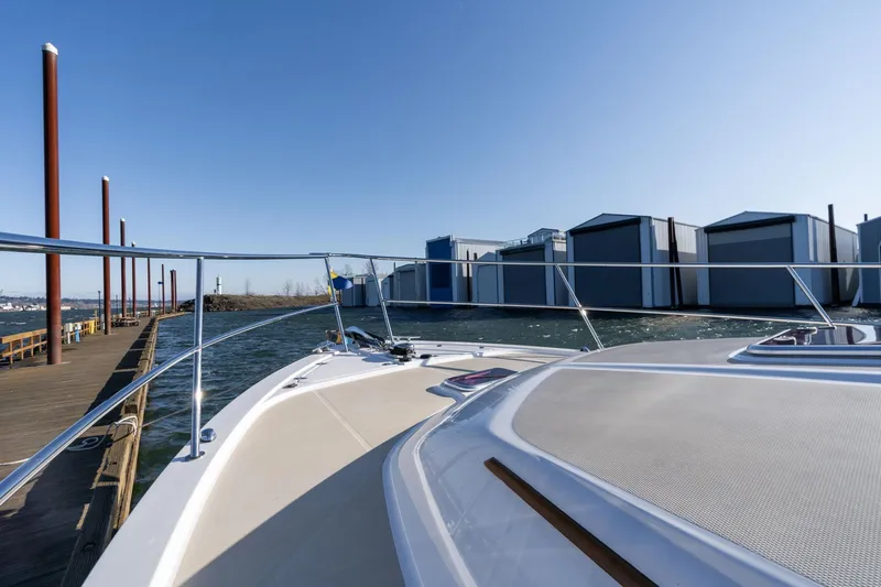 Jackson Yacht Photos Pics 2013 Sabre 38 Salon Express yacht docked near waterfront buildings.