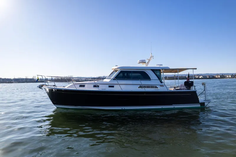 Jackson Yacht Photos Pics 2013 Sabre 38 Salon Express yacht on calm water under clear blue sky.