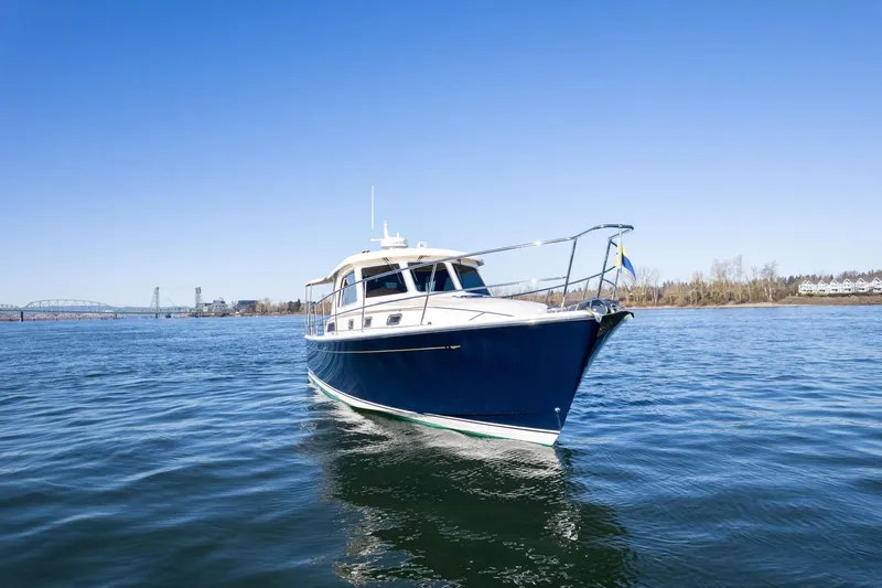 Jackson Yacht Photos Pics 2013 Sabre 38 Salon Express yacht on calm water under clear blue sky.