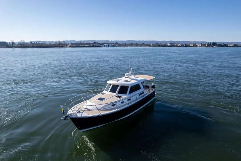 Jackson Yacht Photos Pics 2013 Sabre 38 Salon Express cruising on a calm, scenic waterway.