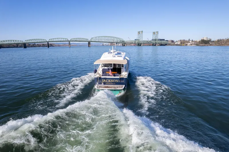 Jackson Yacht Photos Pics 2013 Sabre 38 Salon Express cruising on a river with a bridge in the background.