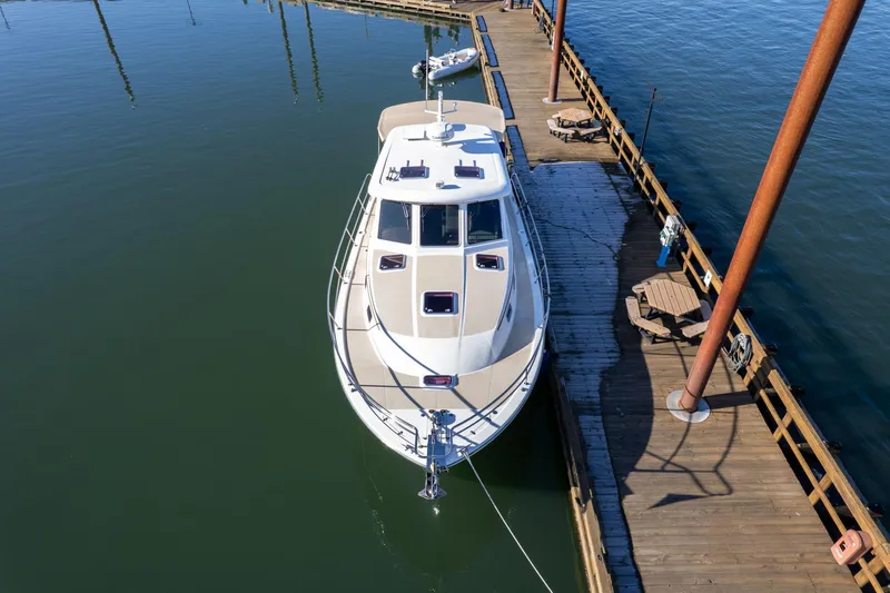 Jackson Yacht Photos Pics 2013 Sabre 38 Salon Express yacht docked at a wooden pier on calm water.