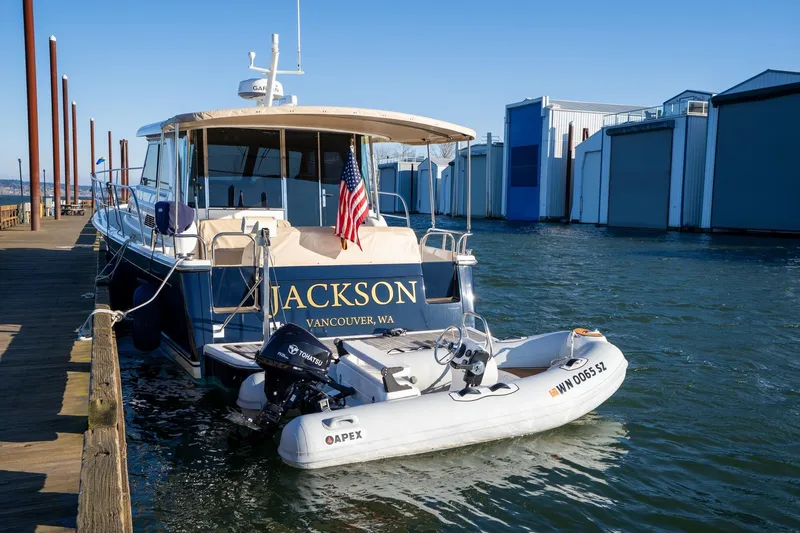Jackson Yacht Photos Pics 2013 Sabre 38 Salon Express docked with inflatable boat, American flag displayed.