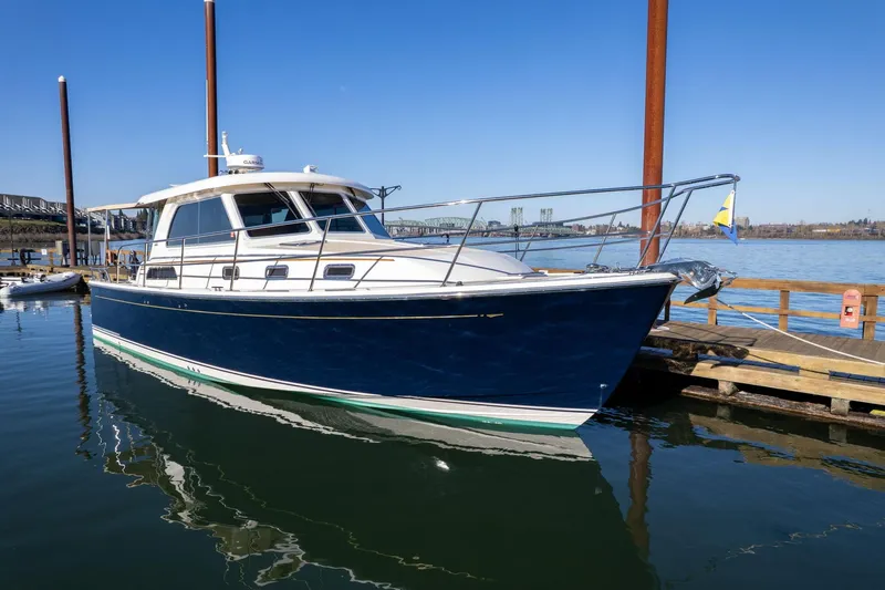 Jackson Yacht Photos Pics 2013 Sabre 38 Salon Express yacht docked at a marina on a sunny day.