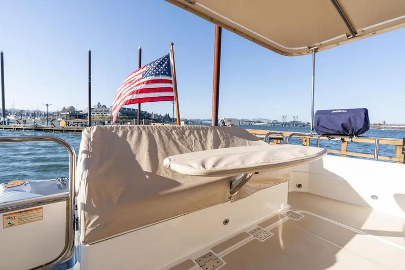 Jackson Yacht Photos Pics 2013 Sabre 38 Salon Express boat deck with American flag, docked by the water.