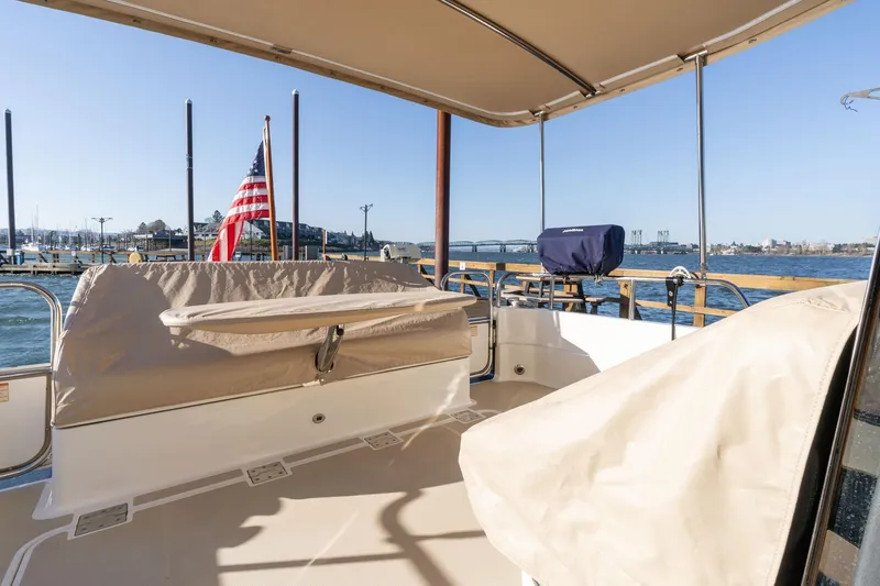 Jackson Yacht Photos Pics 2013 Sabre 38 Salon Express boat deck with American flag, marina view.