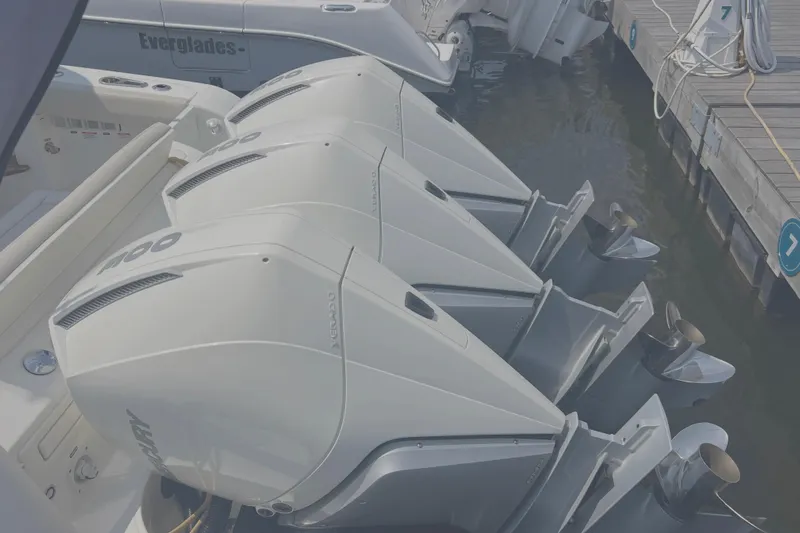  Yacht Photos Pics Triple outboard engines on a 2020 Boston Whaler 350 Realm docked at a marina.