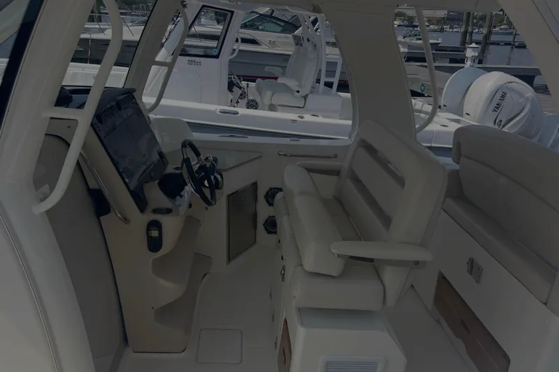  Yacht Photos Pics Interior view of 2020 Boston Whaler 350 Realm boat cockpit with seating and controls.