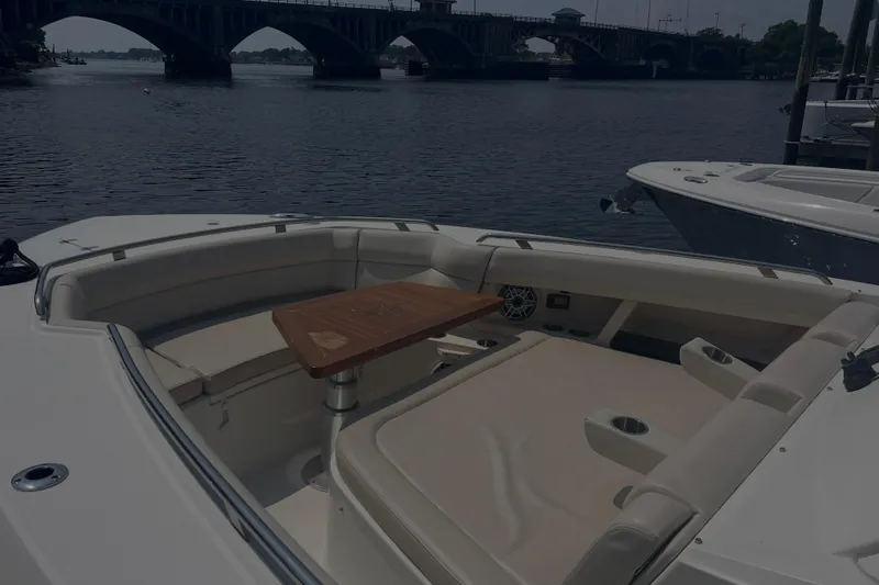  Yacht Photos Pics 2020 Boston Whaler 350 Realm boat interior with seating and table, near a bridge.