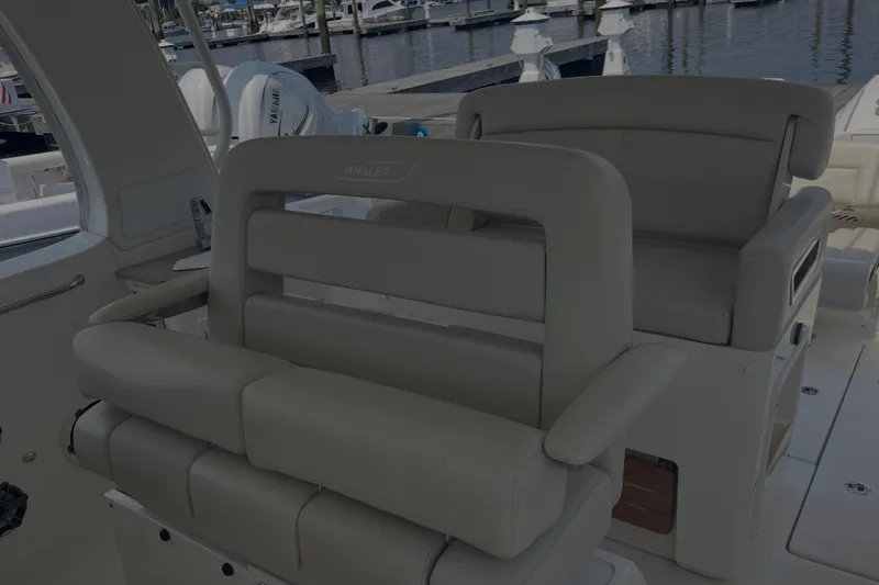  Yacht Photos Pics Interior seating of a 2020 Boston Whaler 350 Realm boat at a marina.