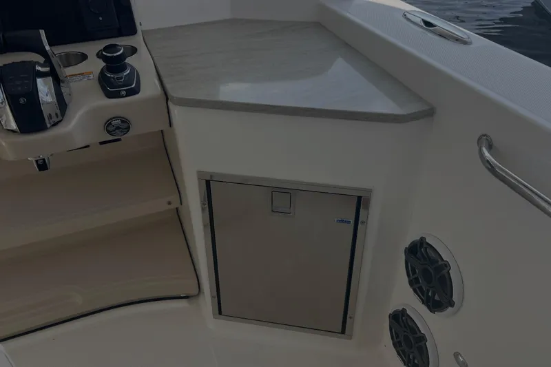  Yacht Photos Pics Interior of 2020 Boston Whaler 350 Realm boat with control panel and storage.