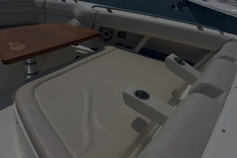  Yacht Photos Pics Luxurious seating area on 2020 Boston Whaler 350 Realm boat with wooden table.