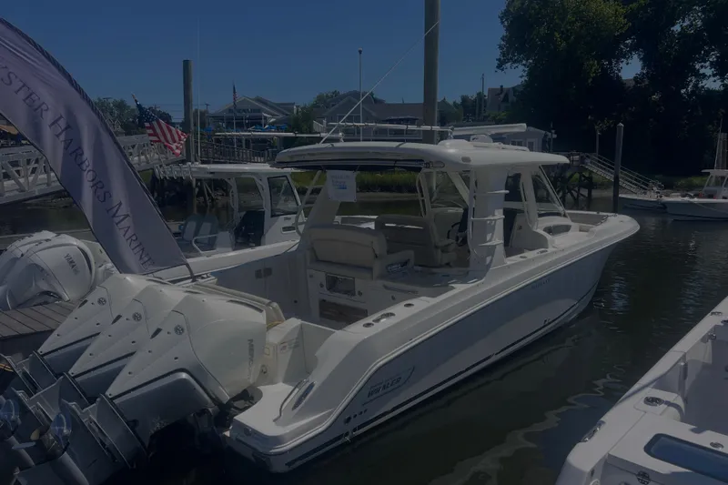  Yacht Photos Pics 2020 Boston Whaler 350 Realm boat docked at a marina with triple engines.