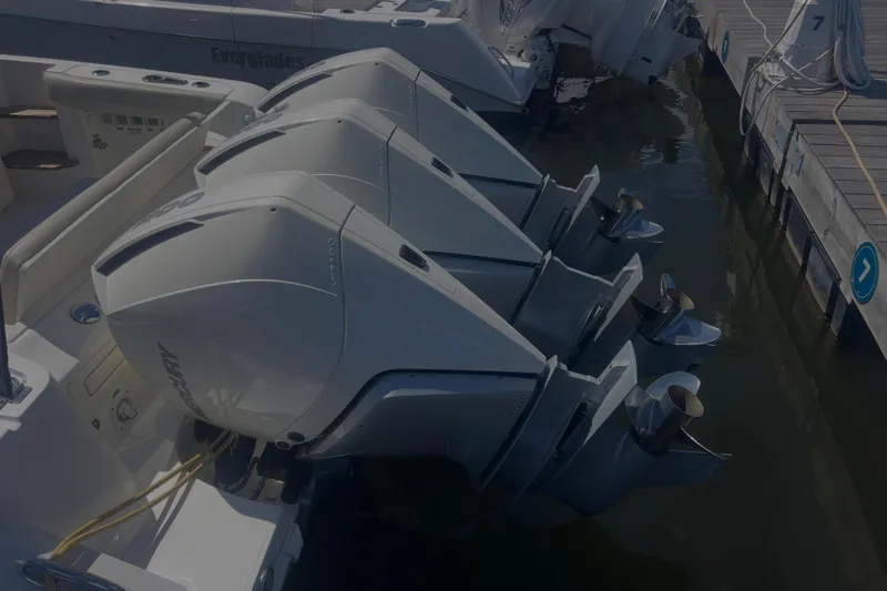  Yacht Photos Pics Triple outboard engines on a 2020 Boston Whaler 350 Realm docked at a marina.