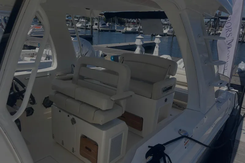  Yacht Photos Pics 2020 Boston Whaler 350 Realm interior with plush seating at a marina.