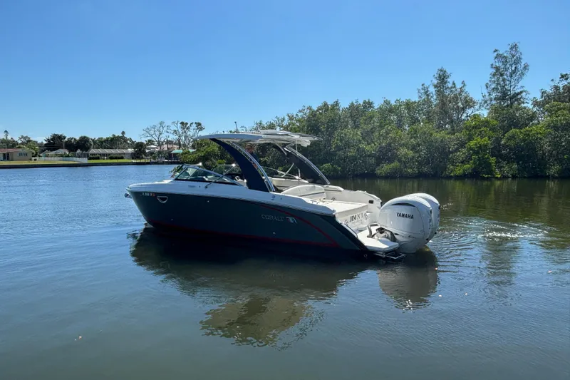  Yacht Photos Pics 2022 Cobalt 30SC boat on a calm river with Yamaha engine.