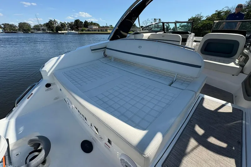  Yacht Photos Pics 2022 Cobalt 30SC boat interior with spacious seating, docked by a scenic waterfront.
