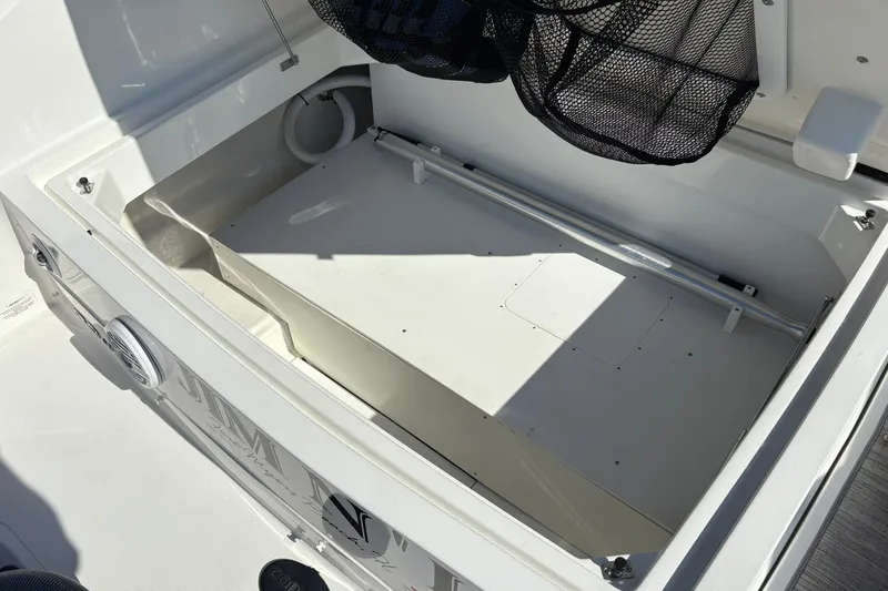  Yacht Photos Pics Storage compartment of 2022 Cobalt 30SC boat, featuring spacious interior and netting.