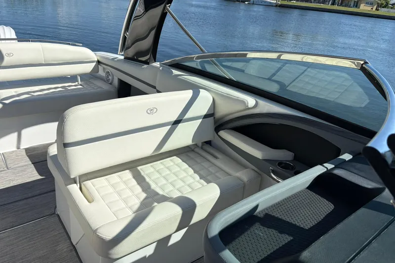  Yacht Photos Pics 2022 Cobalt 30SC boat interior with white seating, on a calm lake.