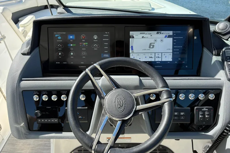  Yacht Photos Pics Steering console of 2022 Cobalt 30SC boat with dual Garmin displays and controls.