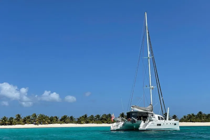 Hera Yacht Photos Pics 2008 Catana 50 catamaran anchored near tropical island with clear blue skies.