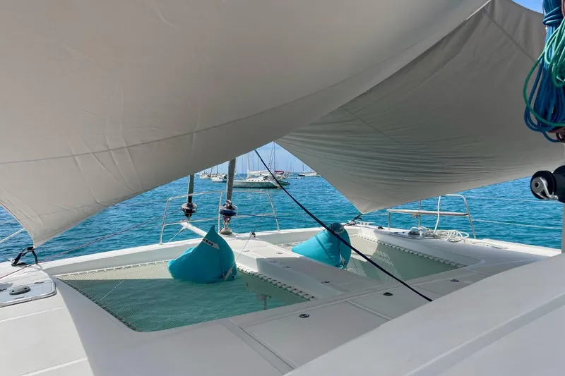 Hera Yacht Photos Pics Catana 50 catamaran deck with sunshade, turquoise water, and bean bags, 2008 model.