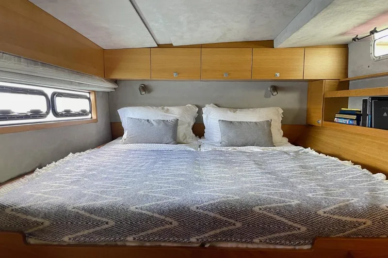 Hera Yacht Photos Pics Cozy bedroom in 2008 Catana 50 yacht with double bed and wooden cabinetry.
