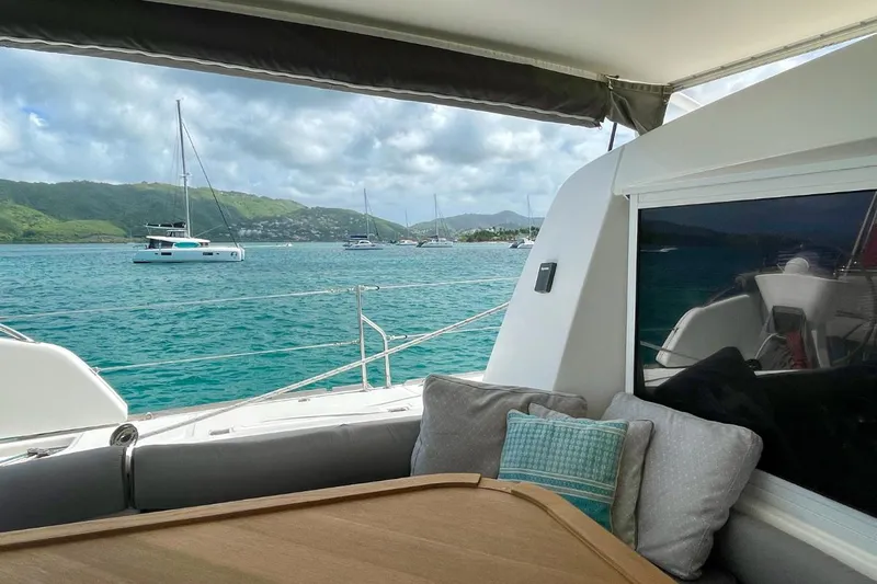 Hera Yacht Photos Pics Catana 50 yacht interior with ocean view, featuring comfortable seating and scenic background.