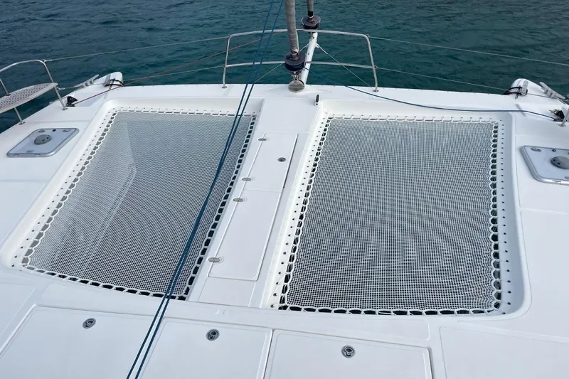 Hera Yacht Photos Pics Catana 50 catamaran deck with netting, 2008 model, on calm water.