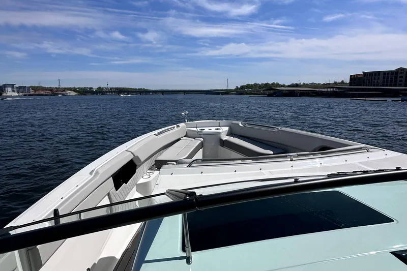  Yacht Photos Pics 2023 Sea Ray SLX 400 OB cruising on a calm lake under a clear blue sky.