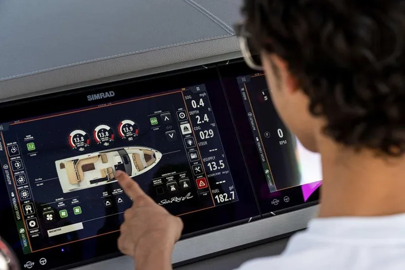  Yacht Photos Pics Person interacting with Sea Ray SLX 400 OB 2023 boat's digital dashboard display.
