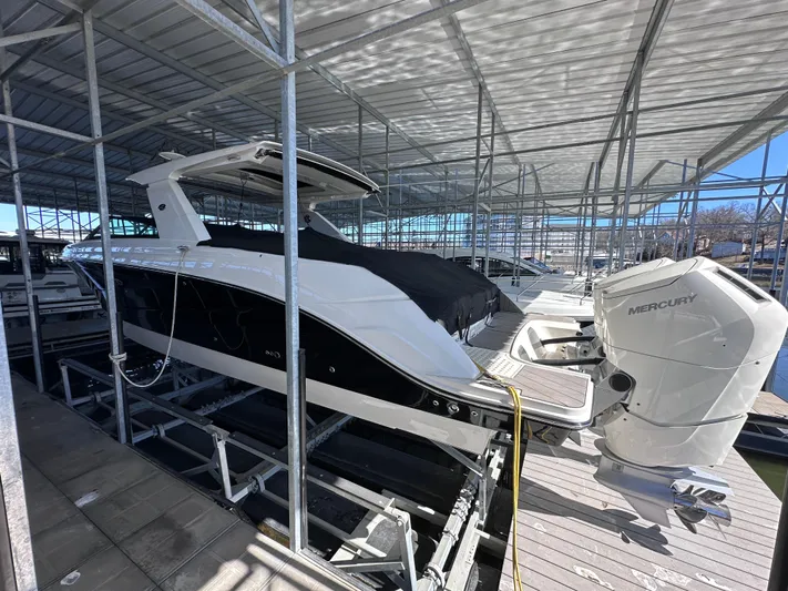  Yacht Photos Pics 2023 Sea Ray SLX 400 OB boat docked under a covered marina.