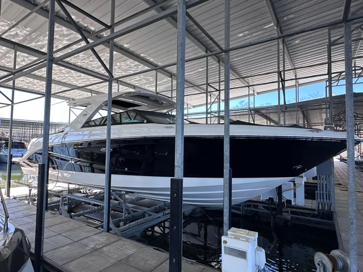  Yacht Photos Pics 2023 Sea Ray SLX 400 OB boat docked in a covered marina.