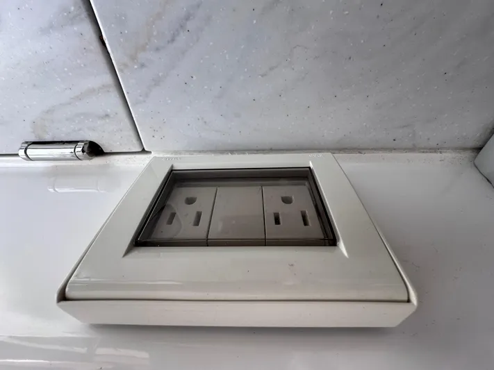  Yacht Photos Pics Electrical outlet on Sea Ray SLX 400 OB yacht, 2023 model, with protective cover.