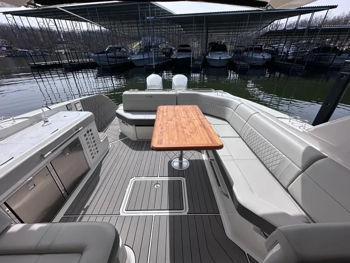  Yacht Photos Pics 2023 Sea Ray SLX 400 OB boat interior with elegant seating and wooden table.