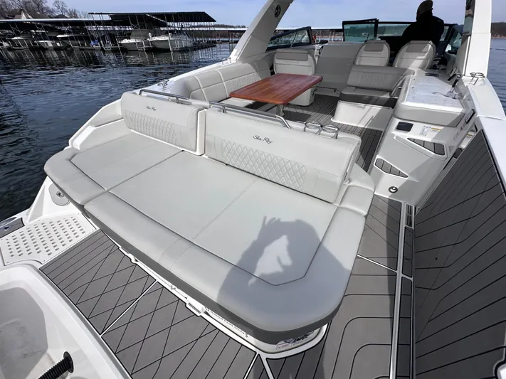  Yacht Photos Pics 2023 Sea Ray SLX 400 OB boat interior with spacious seating and wooden table.