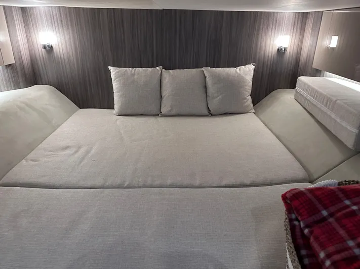  Yacht Photos Pics Interior cabin of 2023 Sea Ray SLX 400 OB with cozy bedding and ambient lighting.