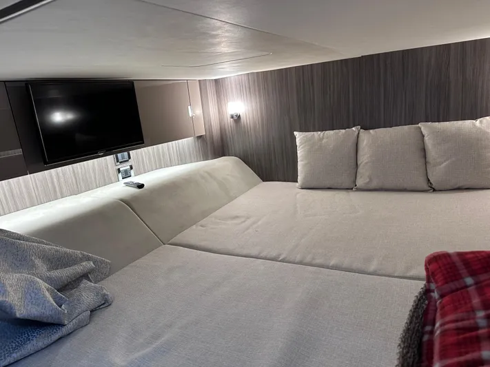  Yacht Photos Pics 2023 Sea Ray SLX 400 OB cabin interior with bed, TV, and modern lighting.