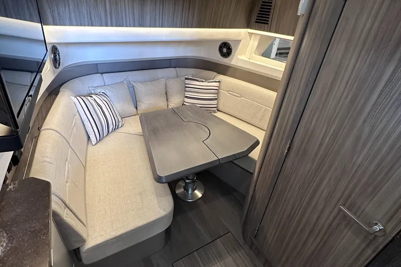  Yacht Photos Pics 2023 Sea Ray SLX 400 OB interior with cozy seating and modern table.