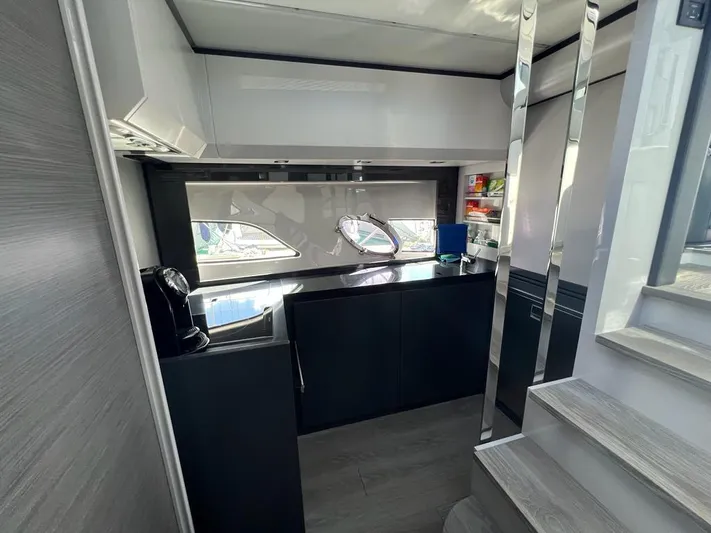  Yacht Photos Pics Modern kitchen interior of 2019 Pershing 5x yacht with sleek cabinetry and appliances.