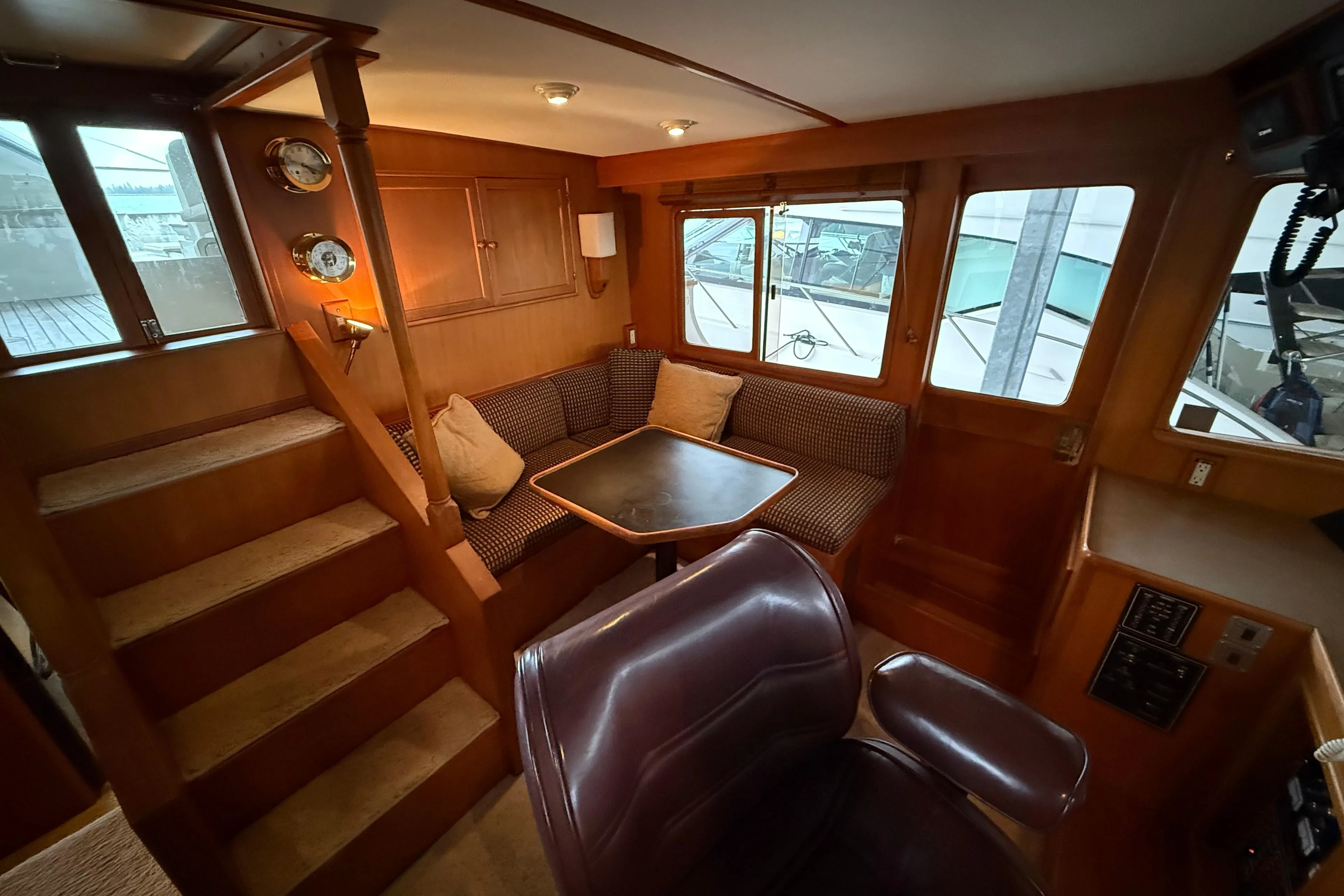 1988 Fleming Pilothouse interior with cozy seating, wooden finishes, and nautical decor.