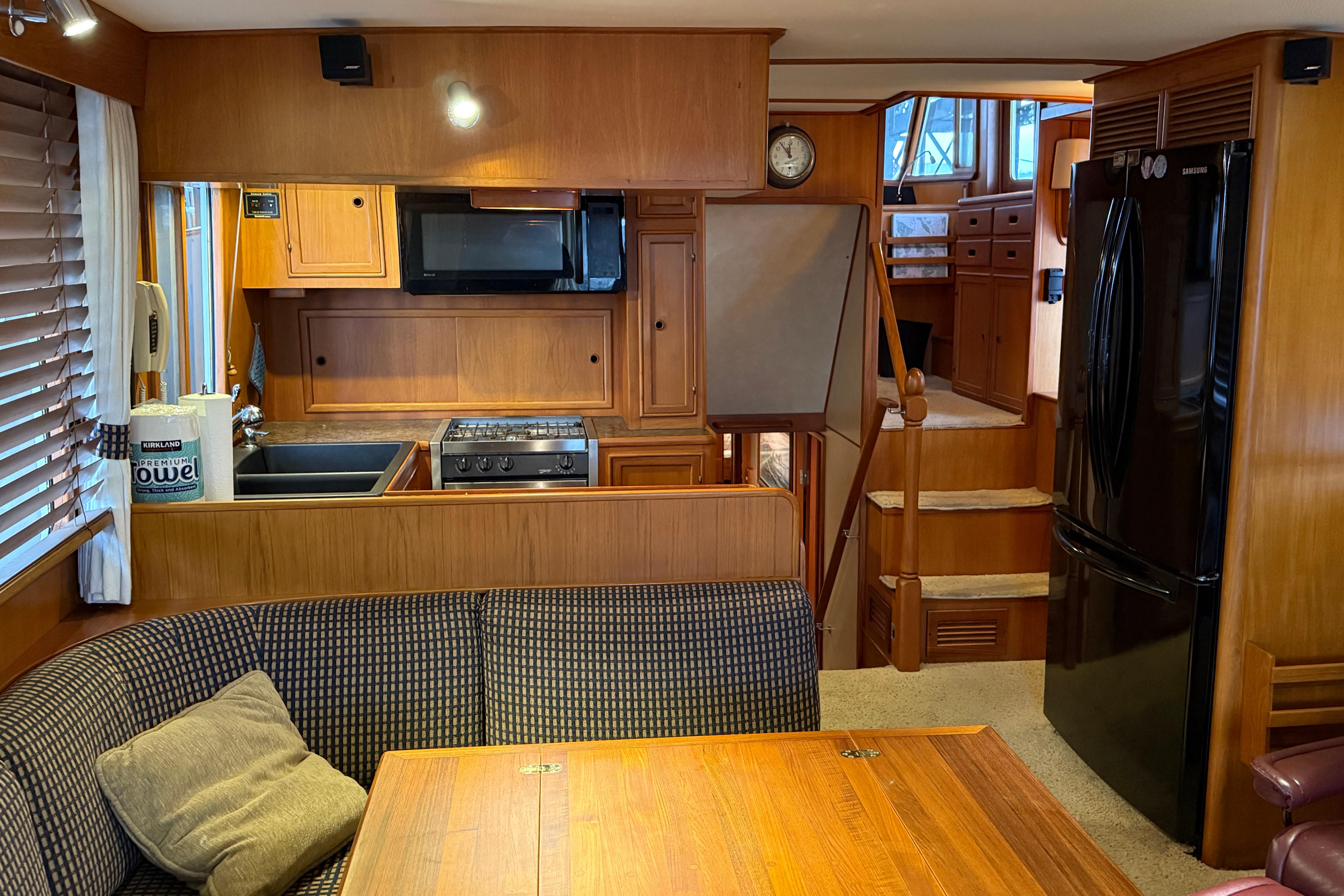 Interior of a 1988 Fleming Pilothouse yacht with kitchen and dining area.