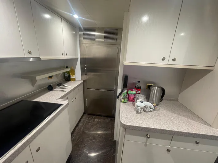 Sarah Sea Yacht Photos Pics Modern kitchen interior on 2004 Kaiserwerft Baron 102 yacht, featuring sleek cabinetry and appliances.