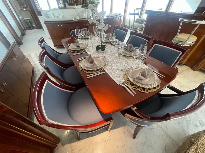 Sarah Sea Yacht Photos Pics Luxurious dining area on 2004 Kaiserwerft Baron 102 yacht, featuring elegant table setting and plush seating.