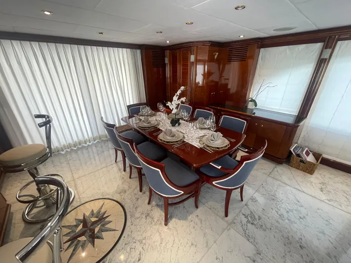 Sarah Sea Yacht Photos Pics Luxurious dining area on 2004 Kaiserwerft Baron 102 yacht with elegant table setting.