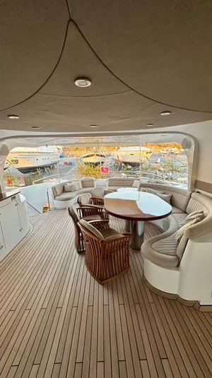 Sarah Sea Yacht Photos Pics Luxurious 2004 Kaiserwerft Baron 102 yacht deck with elegant seating and wooden flooring.