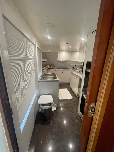 Sarah Sea Yacht Photos Pics Interior view of 2004 Kaiserwerft Baron 102 yacht kitchen with modern amenities.